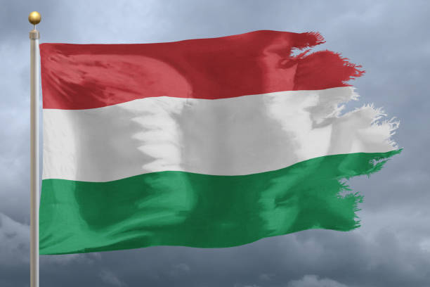Flag of Hungary tattered and torn with stormy sky