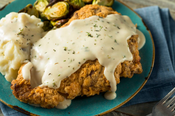 Homemade Country Fried Steak Homemade Country Fried Steak with Gravy and Potatoes gravy photos stock pictures, royalty-free photos & images