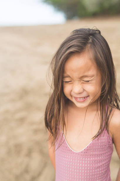 istock Cute young girl posing for camera on Hawaii beach 682423662