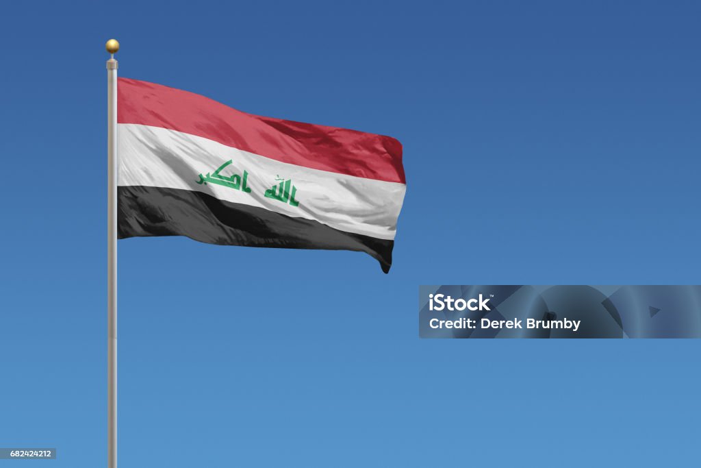 Flag of Iraq Flag of Iraq in front of a clear blue sky Iraqi Flag Stock Photo