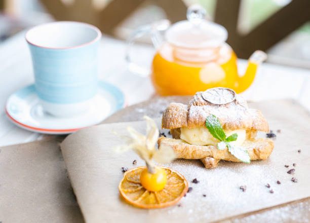 istock Continental breakfast with croissants, orange juice and coffee or tea 682424446