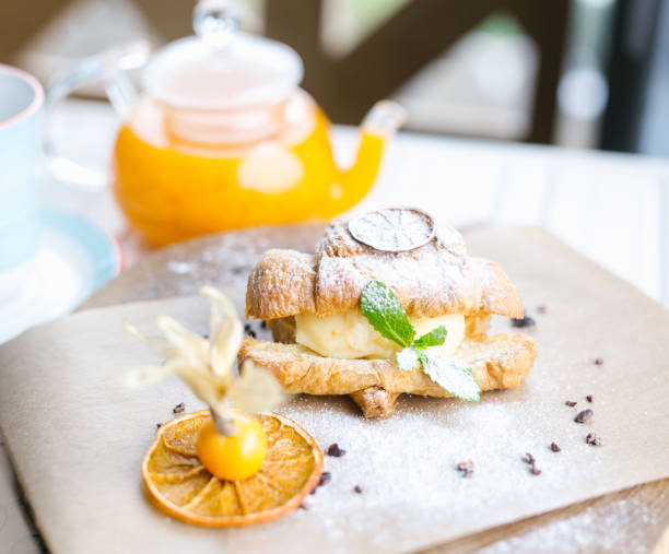 istock Continental breakfast with croissants, orange juice and coffee or tea 682424518