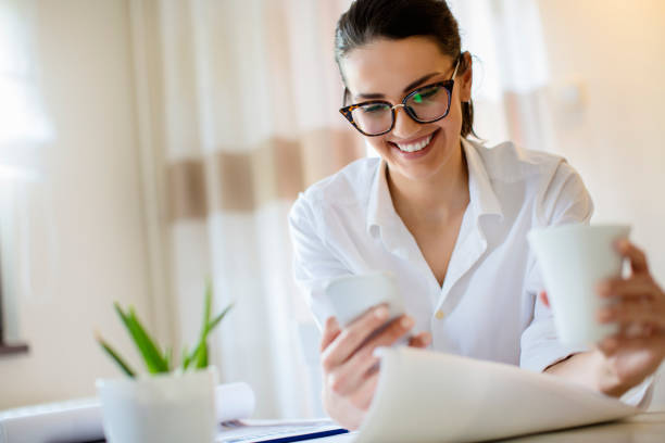 istock Young woman working at home and drinking coffe 682428394