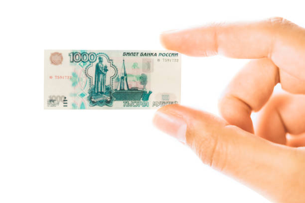 Hand holding small size Russian ruble paper banknote