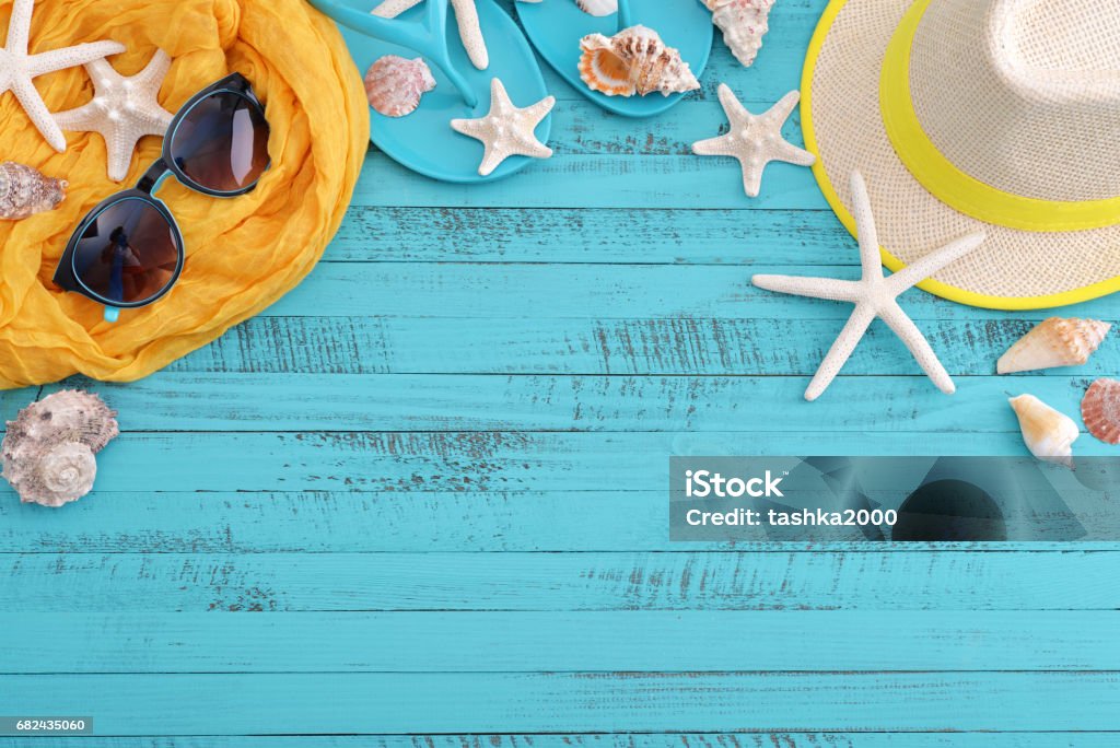 Beach accessories with sea shells Beach accessories with sea shells on blue wooden board Animal Shell Stock Photo