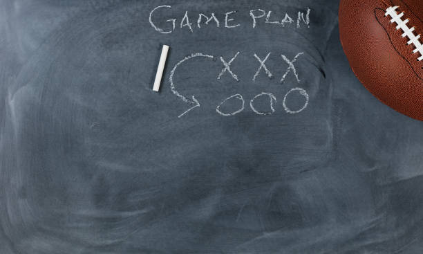 istock American football with game plan on chalkboard setting 682435502