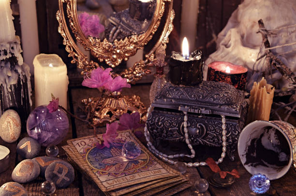 Divination rite with the tarot cards, flowers and mystic objects Halloween background, black magic ritual or spell, occult and esoteric objects on witch table runes photos stock pictures, royalty-free photos & images