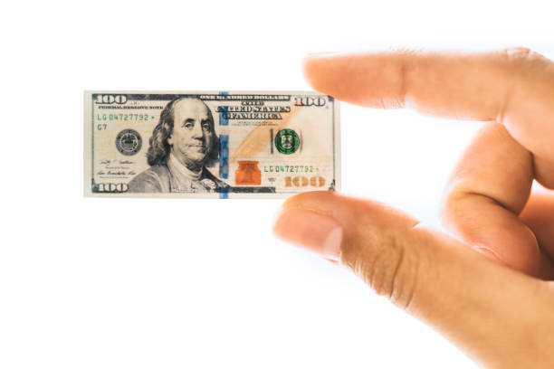 istock Woman hand holding small size American dollar banknote 682444526