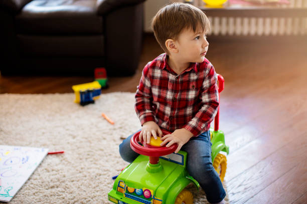 istock Cute little boy driving toy car 682454756