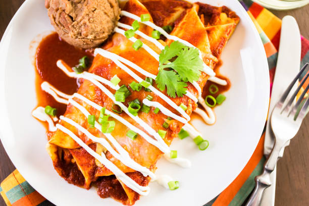 istock Close up of dinner plate with Chicken enchiladas garnished 682454912
