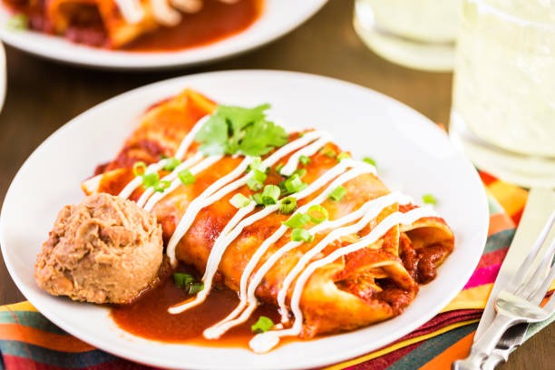 istock Close up of dinner plate with Chicken enchiladas garnished 682454924