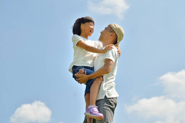 istock Parents and children cuddling in the blue sky (summer) 682455274