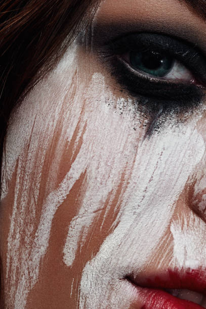istock Woman with smeared White Paint on her Face 682461582