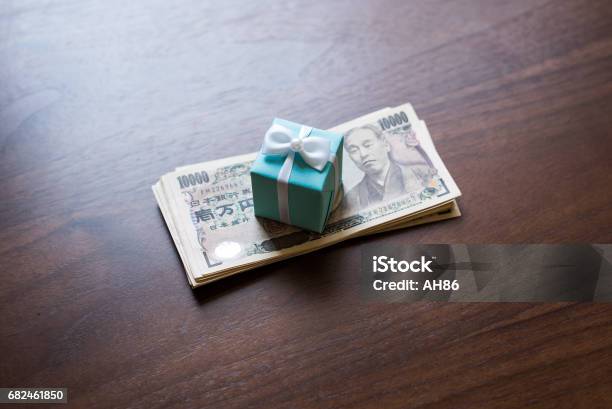 Gift Box And Ten Thousands Yen Bills Stock Photo - Download Image Now - Anniversary, Assistance, Bank - Financial Building