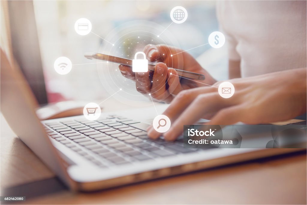 Woman using smartphone Cyber security network Woman using smartphone and laptop with icon graphic Cyber security network of connected devices and personal data security Security Stock Photo