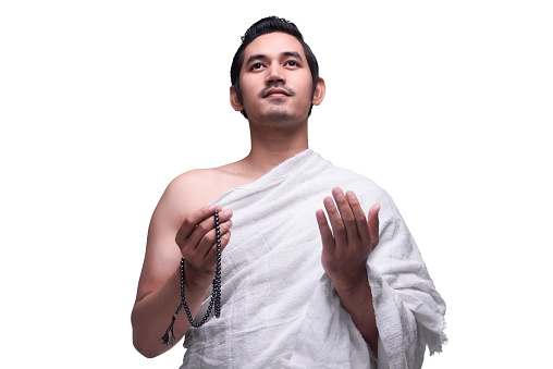 Religious asian muslim man in ihram dress ready for hajj isolated over white background