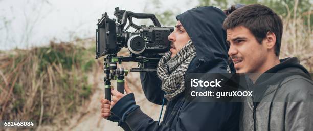 Behind The Scene Cameraman And Film Director Shooting Film Scene Stock Photo - Download Image Now