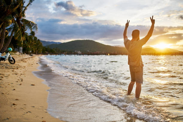 istock cheering farang man passionately observing sunset by himself in thailand 682478634