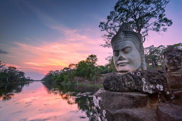 Sculpture outside south gate of Angkor Thom at sunset, Siem Reap, Cambodia The sculpture is on the bridge outside south gate of Angkor Thom . cambodian culture photos stock pictures, royalty-free photos & images