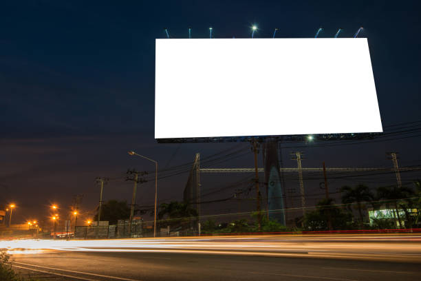 istock Blank billboard for advertisement at twilight time with light trails on the road at dusk 682488692