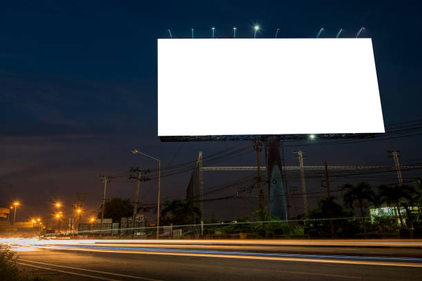 istock Blank billboard for advertisement at twilight time with light trails on the road at dusk 682488694