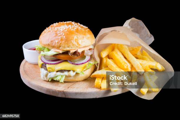 Burger With French Fries Isolated On A Black Background Stock Photo - Download Image Now