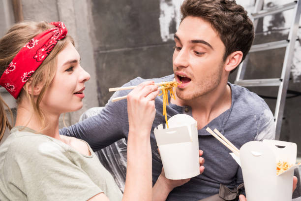 istock couple eating thai food while resting during renovation home process 682496250