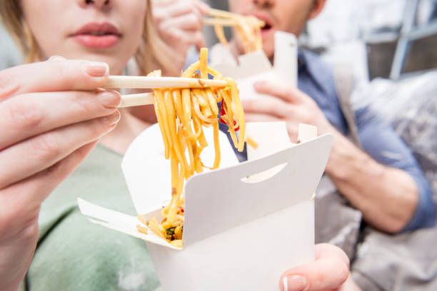 istock couple eating thai food while resting during renovation home process 682497262