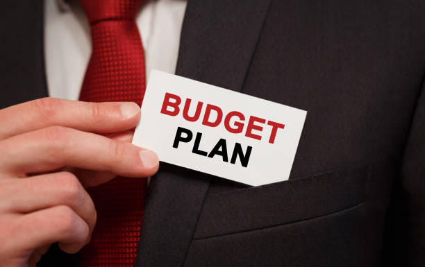 istock Businessman putting a card with text Budget Plan in the pocket 682504932