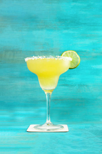 istock Lemon Margarita cocktail on vibrant turquoise with copyspace 682509232