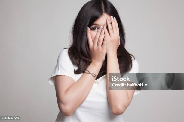 Beautiful Young Asian Woman Peeking Through Fingers Stock Photo - Download Image Now