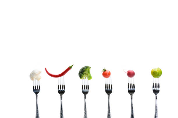 istock fresh vegetables on forks isolated on white, healthy living concept 682517186