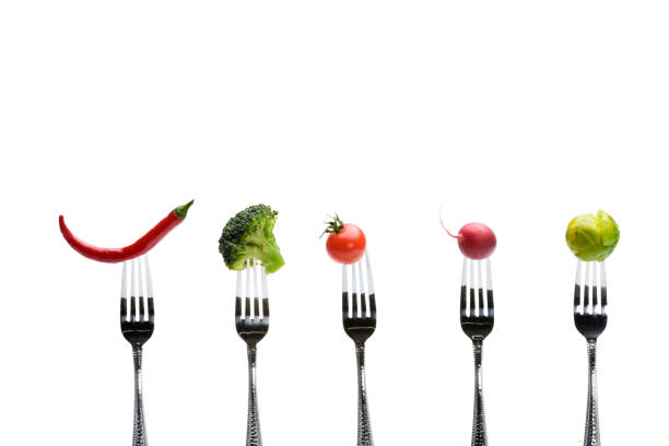 istock fresh vegetables on forks isolated on white, healthy living concept 682517534