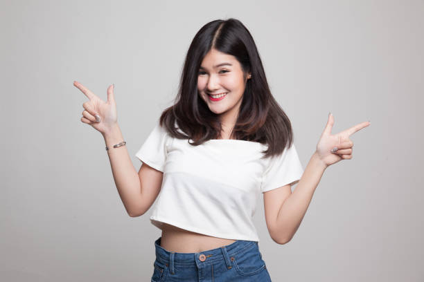 istock Young Asian woman point to left and right. 682517928