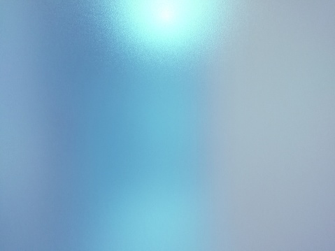 Blurred frosted glass texture background with light reflection, Grey and blue colors.