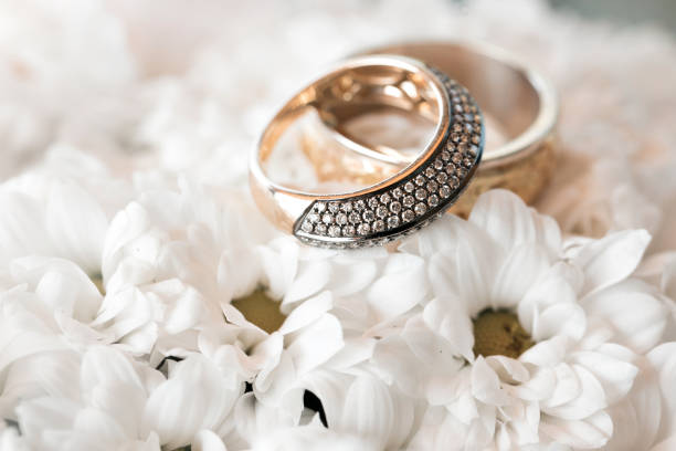 istock Wedding rings on a white flowers. accessories wedding closeup. selective focus 682523572