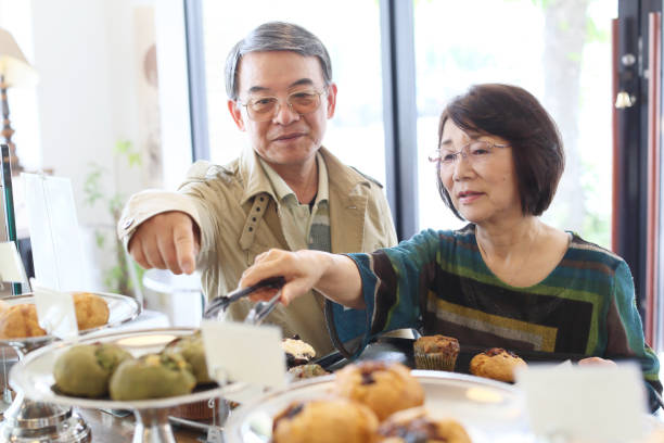 istock Elderly couple shopping at a cafe 682535334