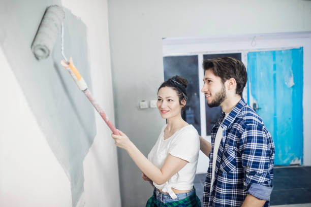 istock Young couple painting walls 682535968