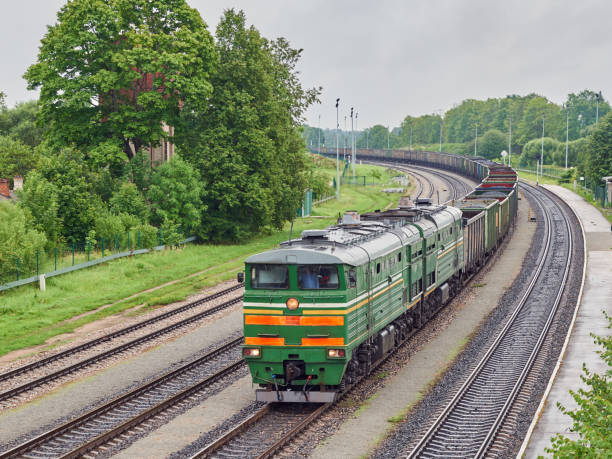 Diesel locomotive and coal wagons on railway tracks stock photo