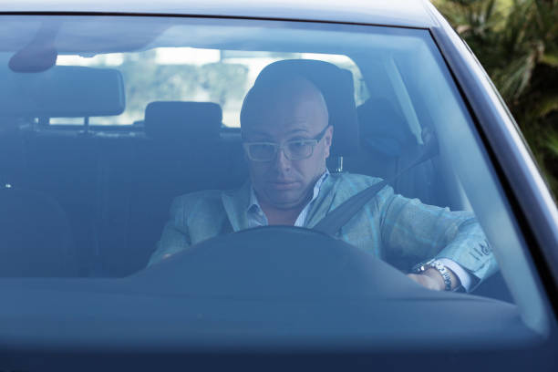 istock Shocked scared anxious funny looking young driver in the car. Human emotion face expression. Front window view of inexperienced driver concept 682547390