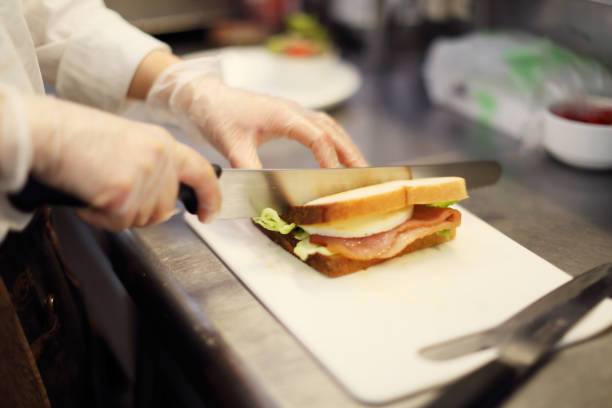 istock The salesclerk who cuts a sandwich 682551158
