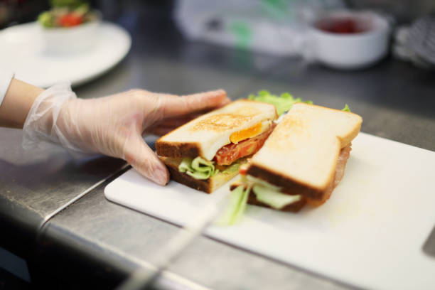istock The salesclerk who cuts a sandwich 682554860