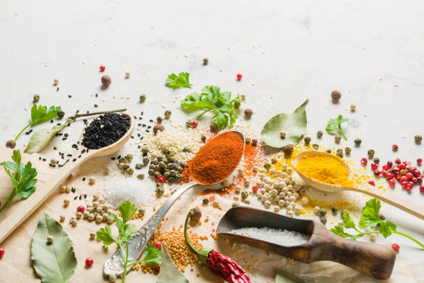 istock Spices in different spoons on a stone white background. A scattering of spices. 682554958