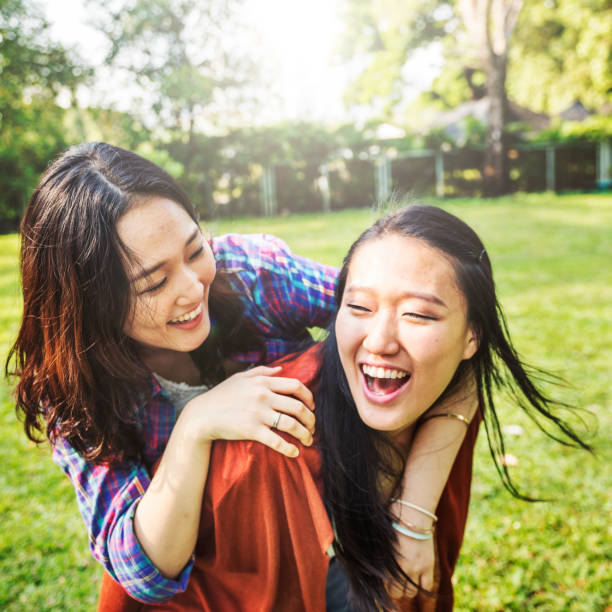 istock Sister embracing smiling in a park 682560270