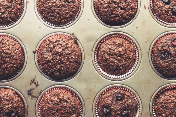 istock Chocolate bran muffins with cherries, in old, grunge looking, tin tray 682560994