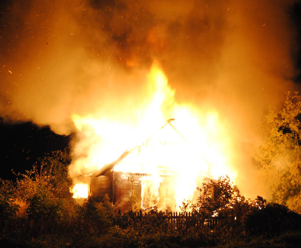 istock House fire with heavy flame, glowing roof and chimney. 682564106