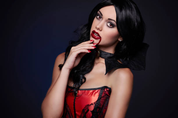 Sensual female vampire with blood on the lips Sensual female vampire with blood on the lips vampire woman stock pictures, royalty-free photos & images