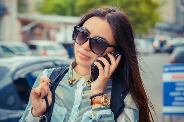 istock Woman talking at phone. City reflection on sunglasses 682568120