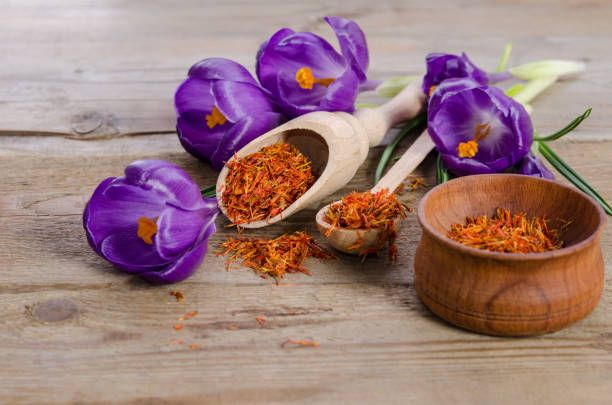 istock crocus flowers and spoon with soffron  on wooden table 682575326