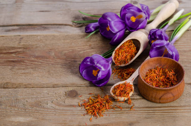 istock crocus flowers and spoon with saffron  on wooden table 682575332